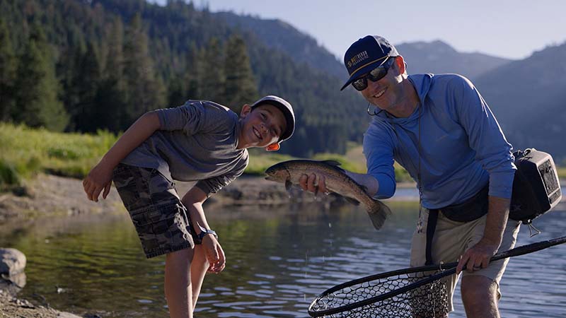 Fly-fishing guide Matt Heron and his son pose with a rainbow trout caught on the property’s stocked pond. Photo courtesy of Everline Resort