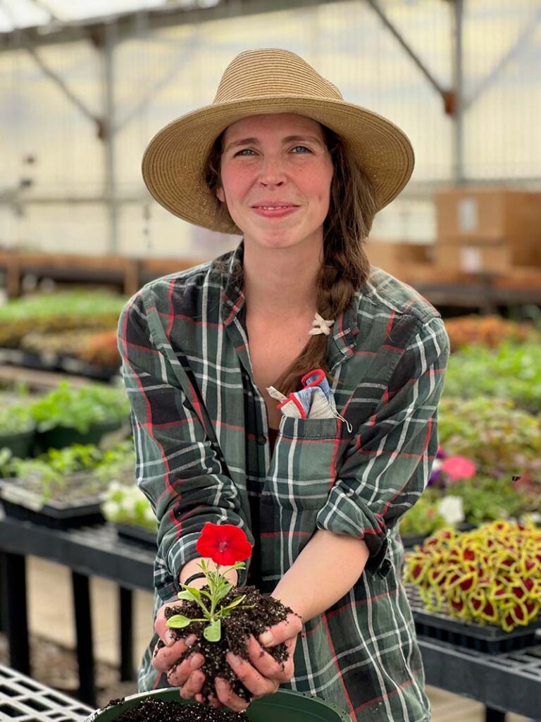 Elsa volunteers in the master gardener greenhouse, preparing plants for the annual seedling sale. Photo courtesy of Rachel McClure