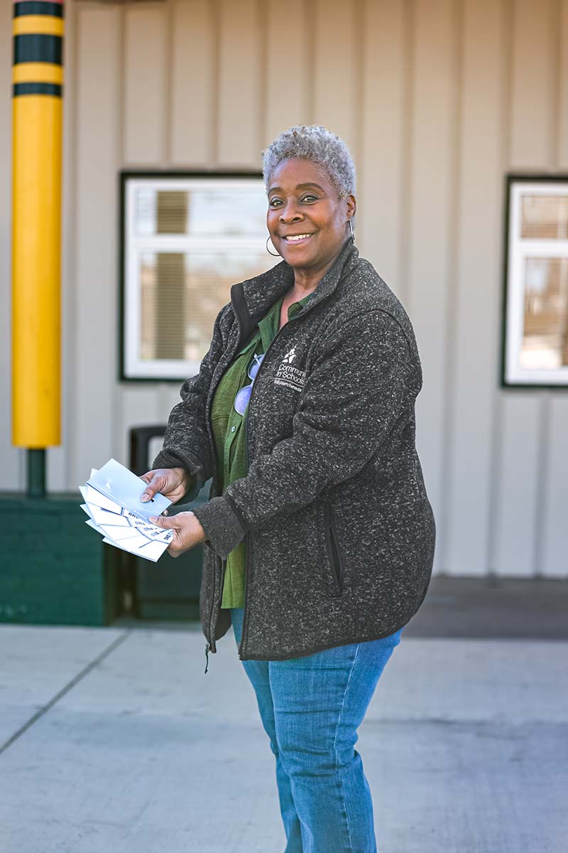 BJ Foster, senior program director with Communities in Schools, offers gift cards to students at Duncan Elementary School in Reno as part of The Third Meal program