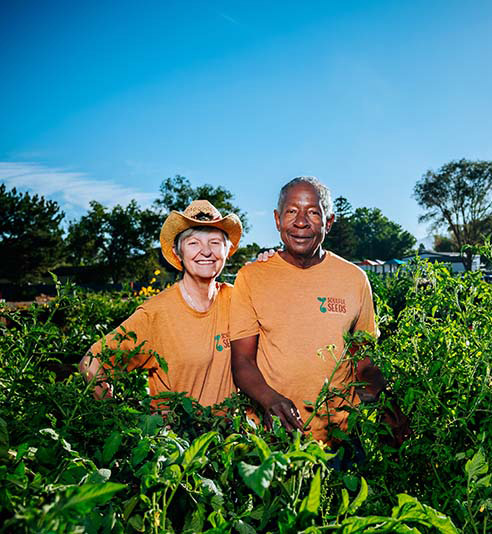 Dolores (Dee) Schafer-Whitten and Earstin Whitten, cofounders of Soulful Seeds, stand by their pepper and tomato plants