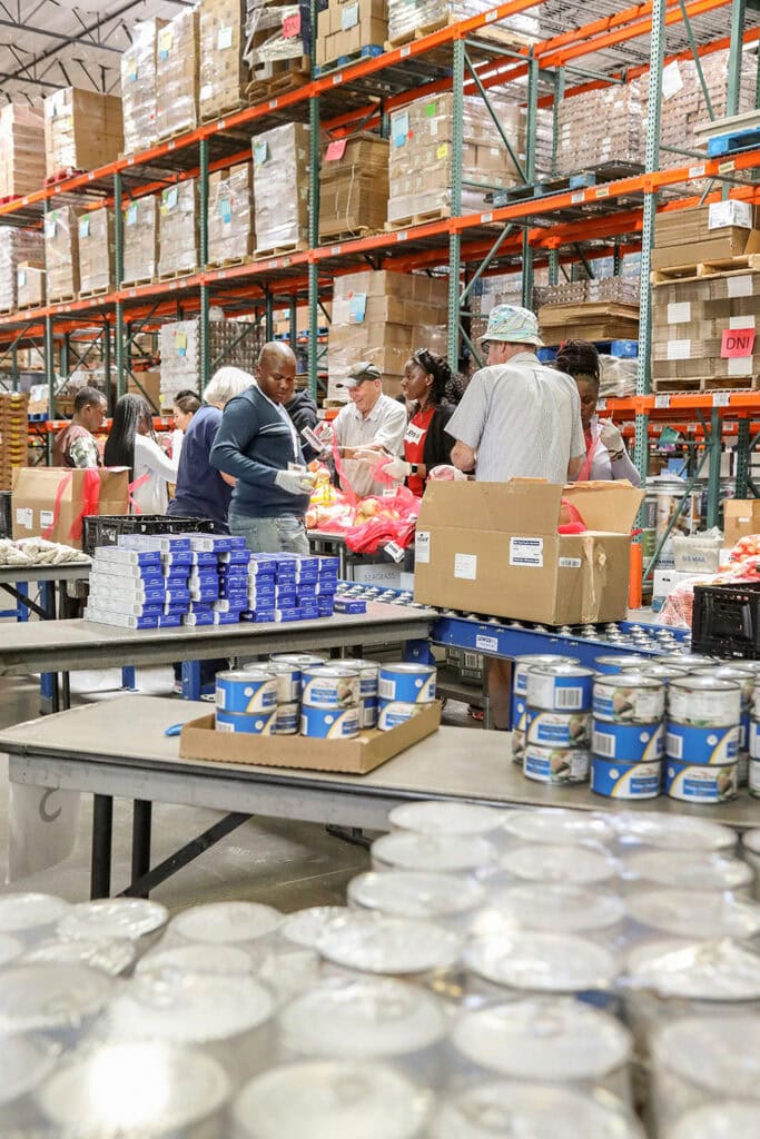 A team from the Northern Nevada International Center and other volunteers help pack produce at the Food Bank of Northern Nevada Warehouse in Sparks