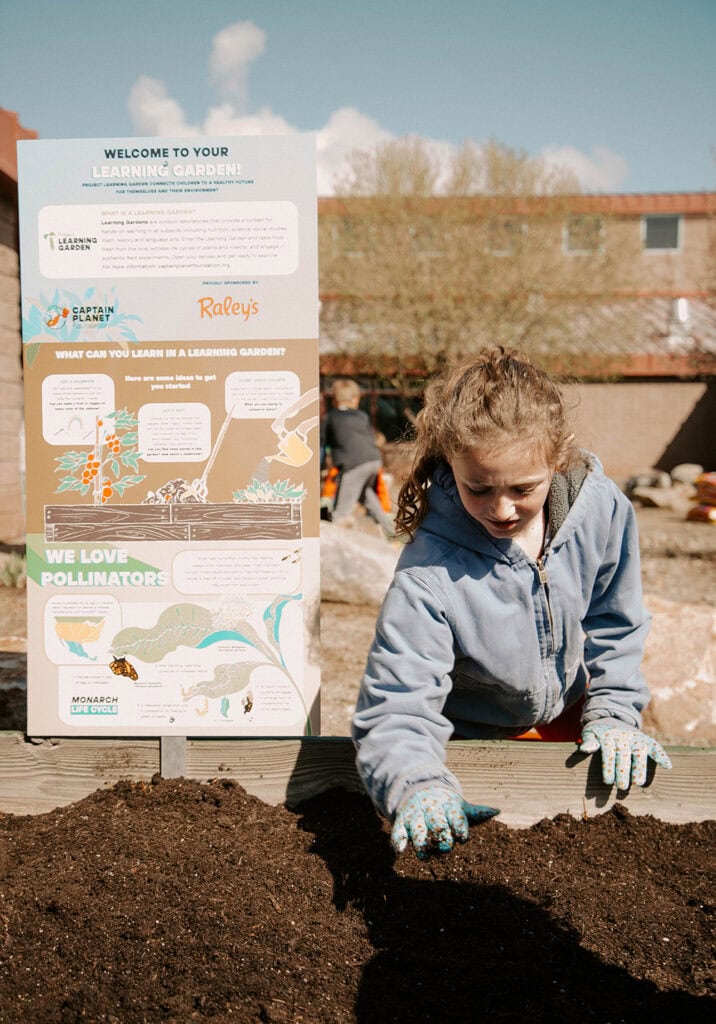 A student at Alyce Taylor Elementary plants seeds and starts in raised beds. Photo courtesy of The Raley’s Companies