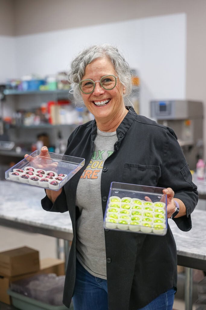 Tandem Chocolates owner Phyllis Robinson displays chocolates decorated using techniques taught at one of her in-shop classes