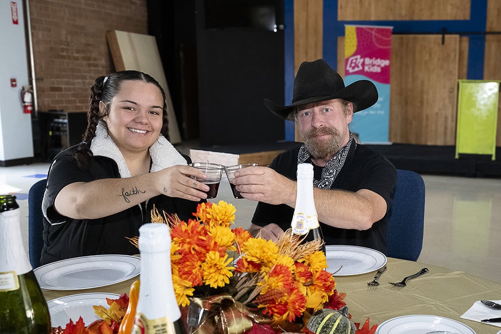 Hill and Ashley Gallegos, administrative assistant at The Bridge Church, toast a successful Thanksgiving meal. Photo by Mary Claire Bouchér