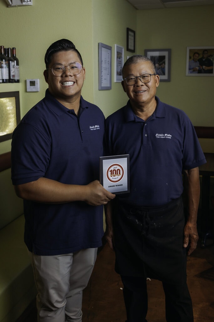 Danny Nguyen and his father, Kwok Chen, proudly display their “Top 100 Chinese Restaurants in the U.S.” award from Yelp