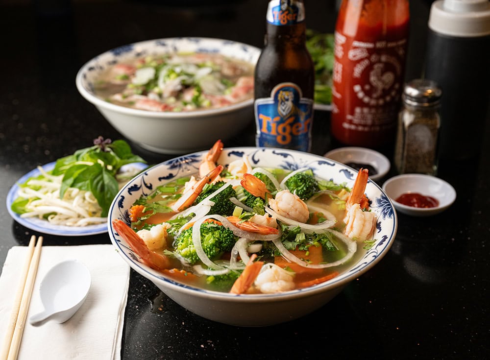 Pho rau tom (front) and xe lua (back), both beef noodle soups, and a Vietnamese beer, at Pho 777 in Reno. Photo by Jeff Freeman