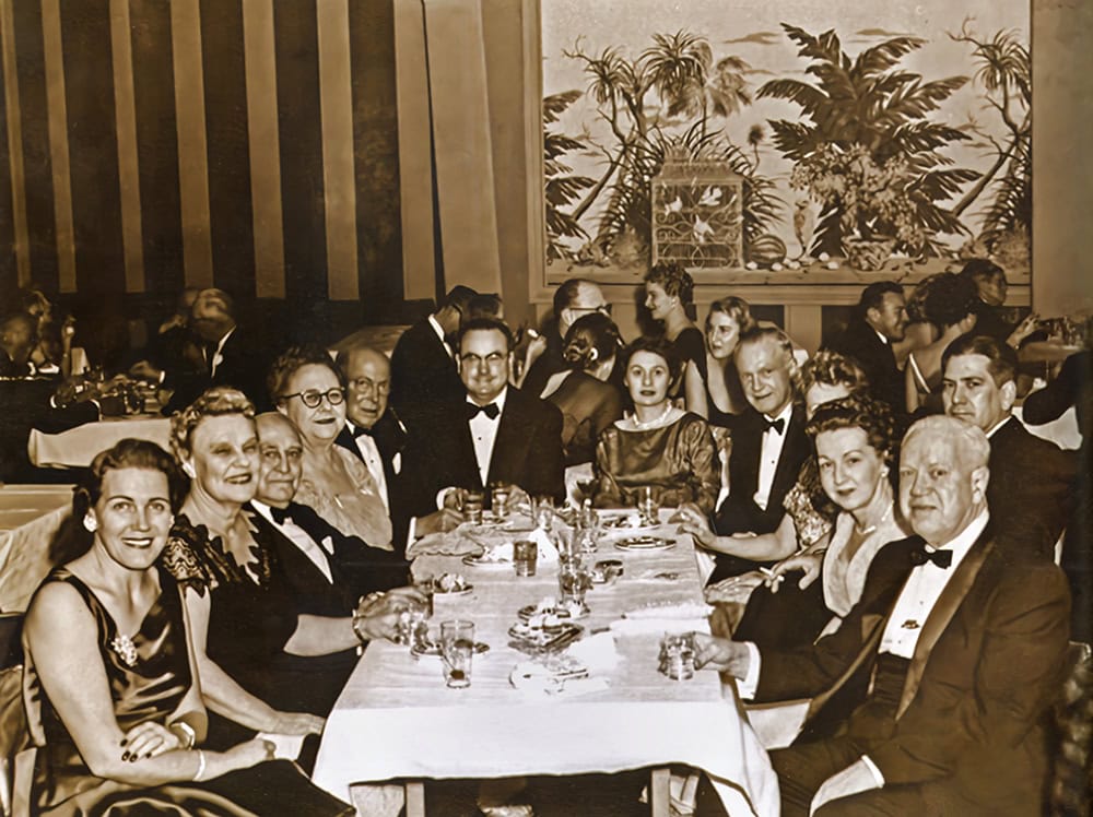 Club members and their wives enjoy the holiday party, circa 1950s