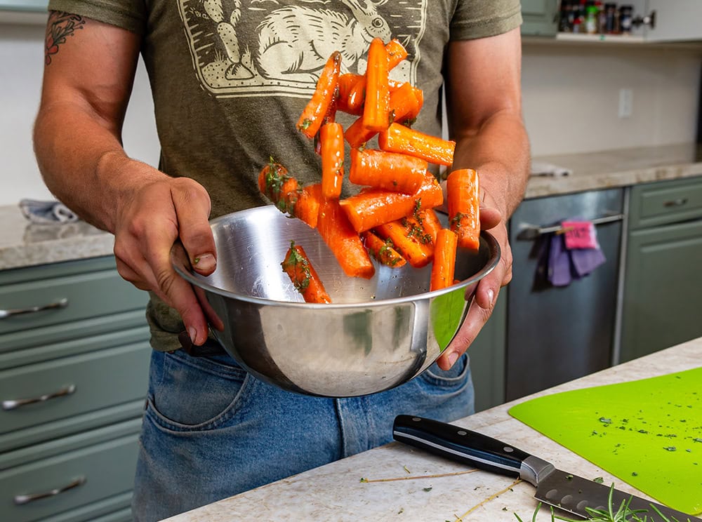 Zipkin tosses chopped carrots with seasoning