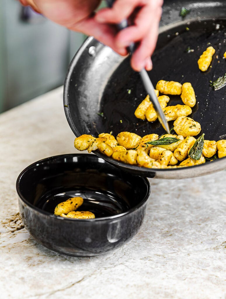 To make gnocchi, Zipkin makes dough with potatoes and egg, cutting them into small pieces, then pan-frying them with oil and herbs
