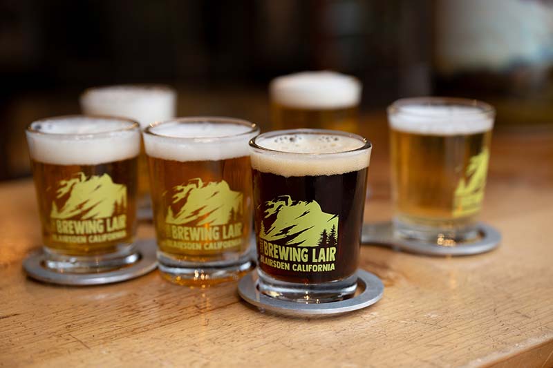 A flight of beers at The Brewing Lair includes Louie, a fresh hop; Life of Mine, a modern lager; Ambush, a West Coast IPA; Deep Cover, a dark IPA; BLT, a Belgian Tripel; and Acclimation Sour