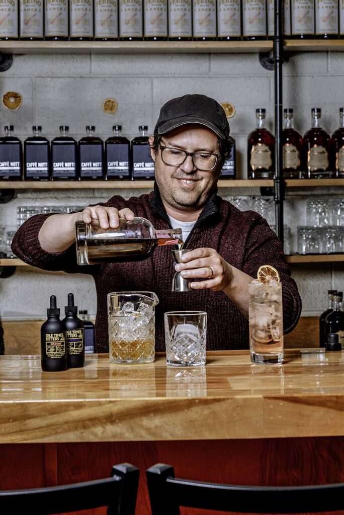 Ferino Distillery owner Joe Cannella uses his Idle Times line of bitters to make a grapefruit cocktail (in tall glass) and an old fashioned