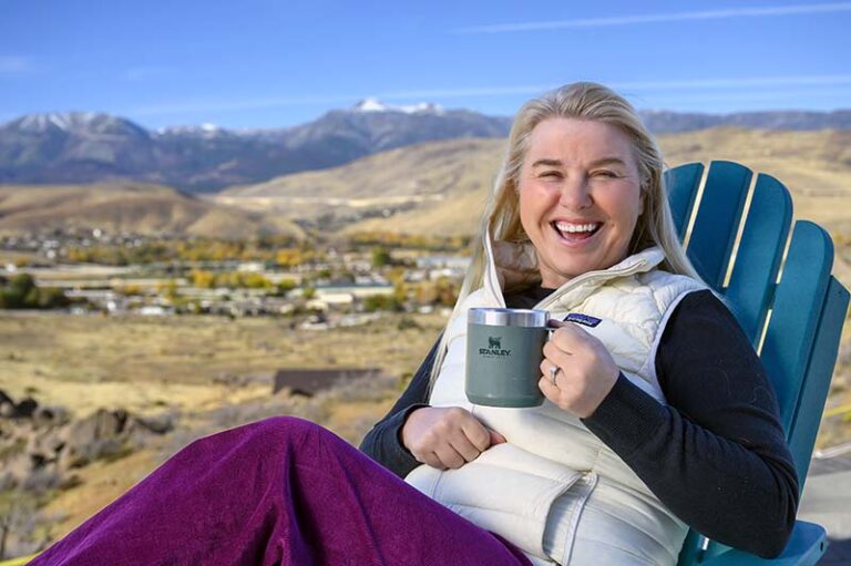 Abbi Whitaker lounges in her backyard with a Stanley pour-over mug of coffee