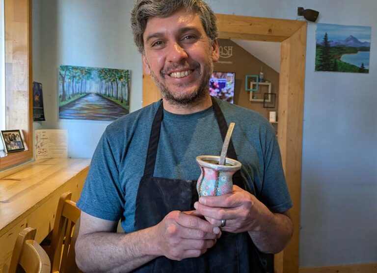 Empanash owner Martín Mariani walks around his shop with his yerba mate gourd and bombilla